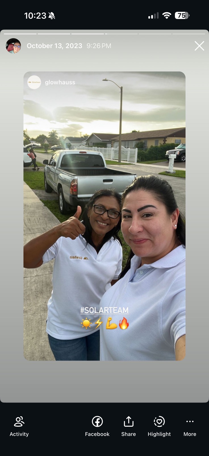 Two Glowhaus reps in branded polos giving a thumbs up in the field with the company truck, captioned #SolarTeam.