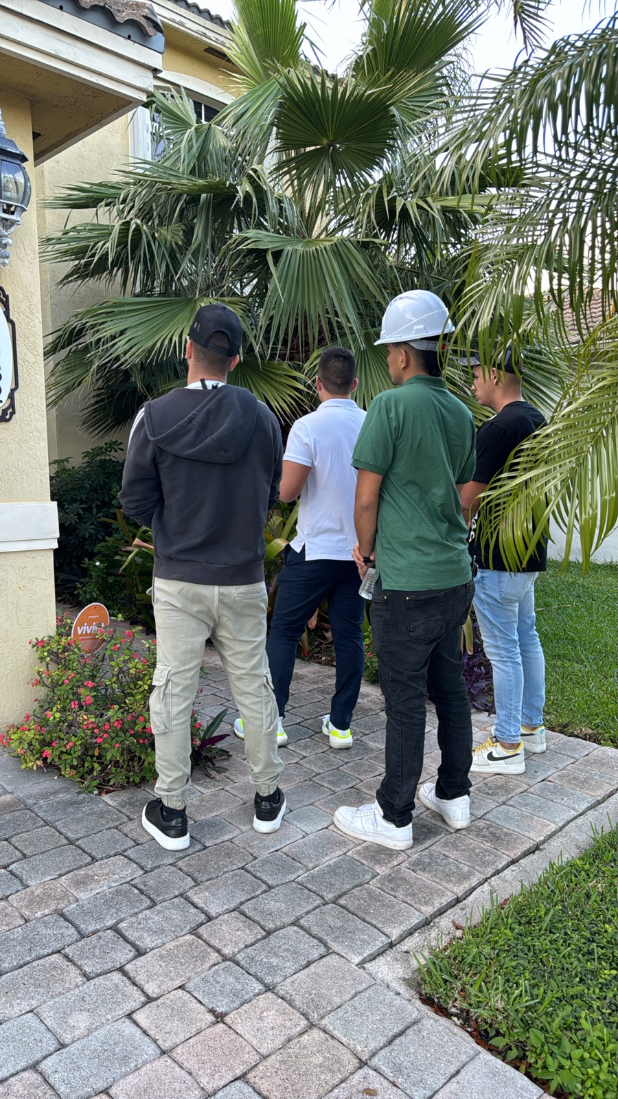 John taking a group of new Glowhaus appointment setters to a home's front door in Miami for door-knock training.